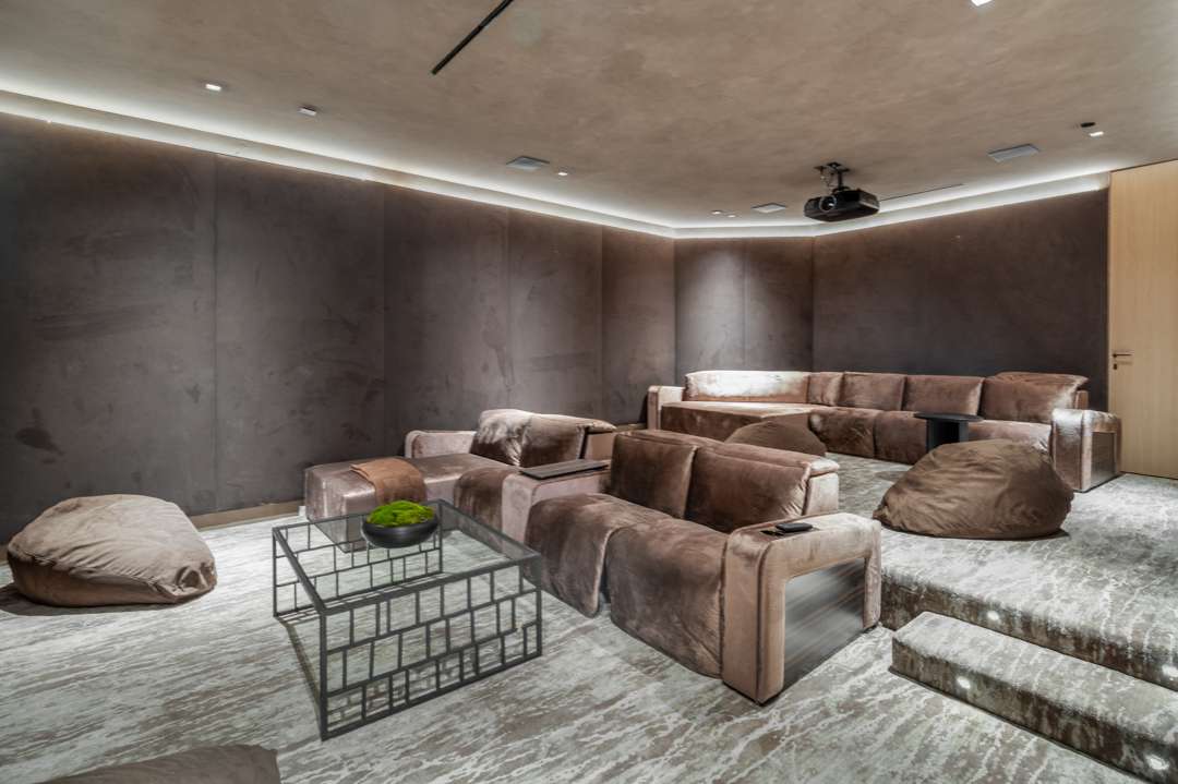 Home movie theater with brown couches