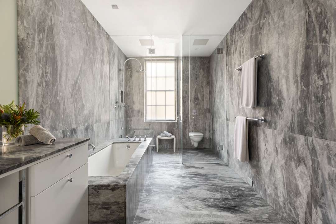 Grey marble bathroom with built in tub and leveled shower