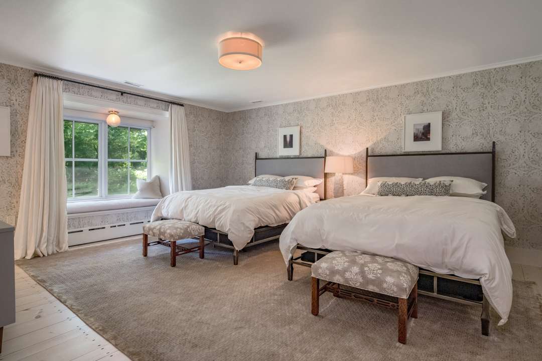 Gray and white bedroom with two queen beds
