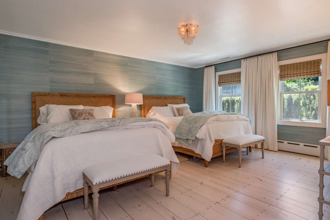 Blue and white bedroom with two queen beds