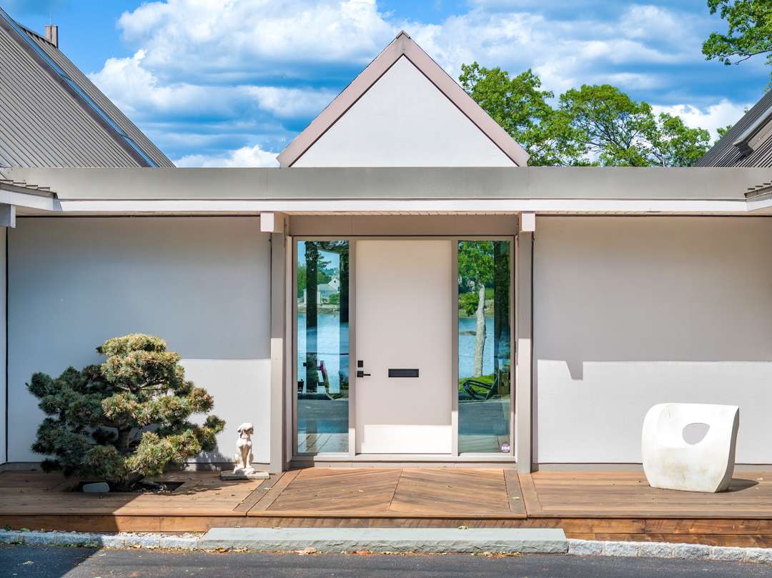 White front door with wood front deck