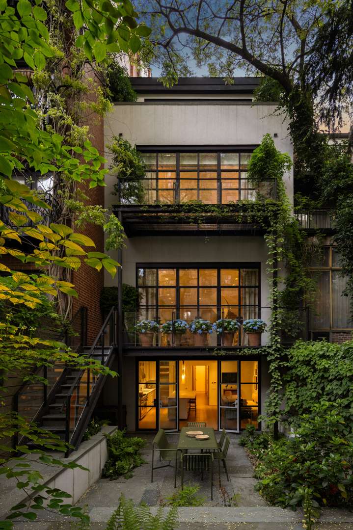 Outside of Chelsea Townhouse with flowers and plants and outdoor dining table