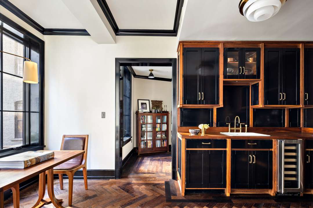 Kitchen with black cabinets and wood counters