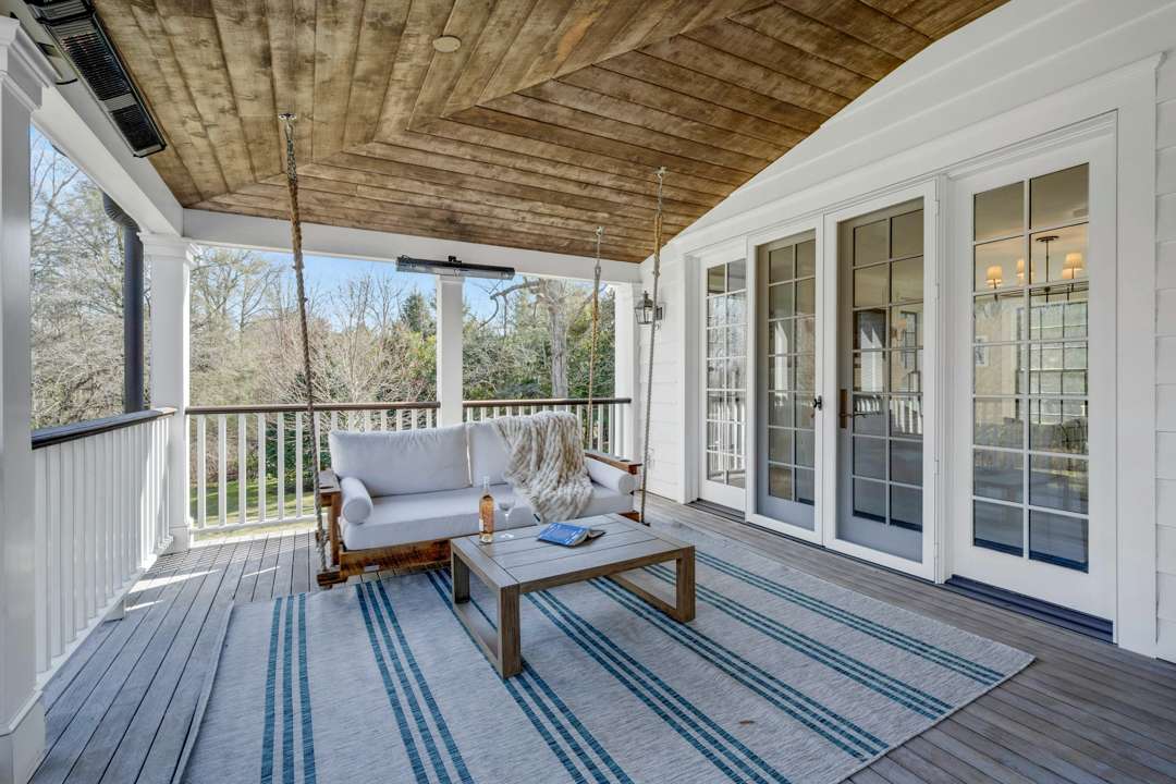 Bethenny Frankel's Greenwich house blue and white outdoor deck with swinging couch