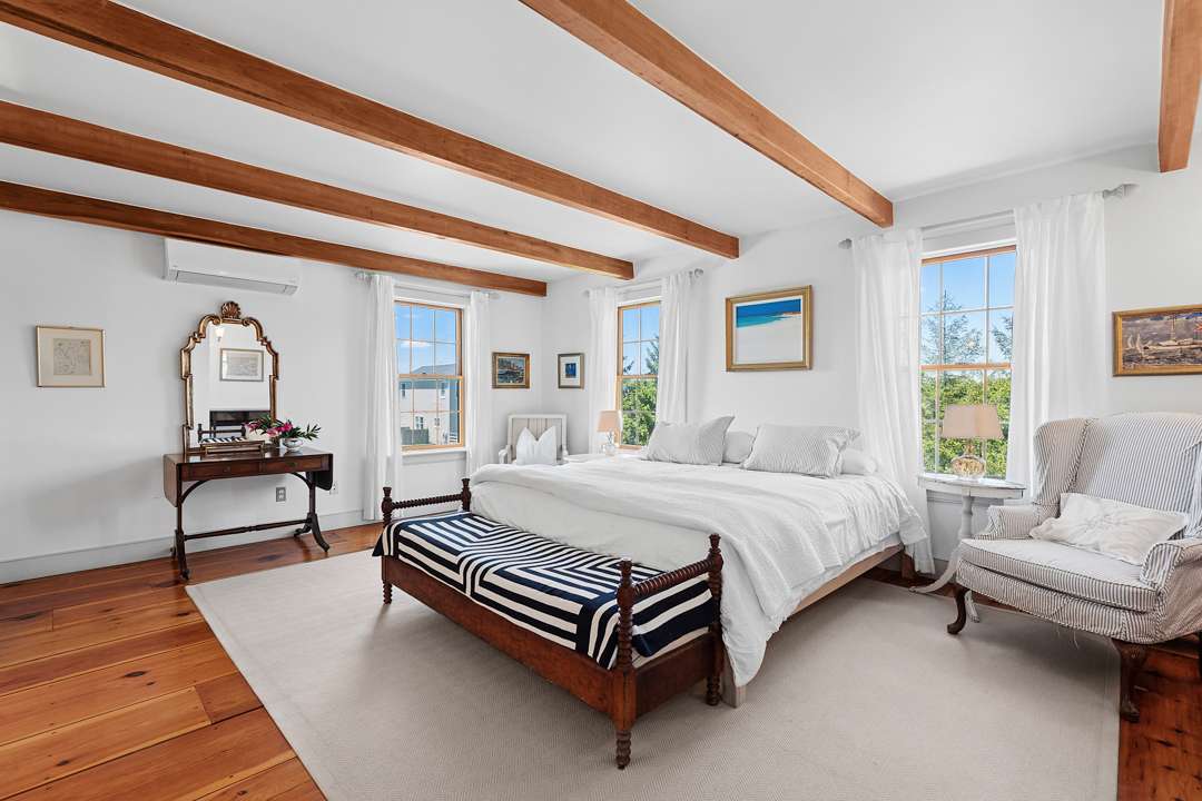 White bedroom with wood furniture and blue accents