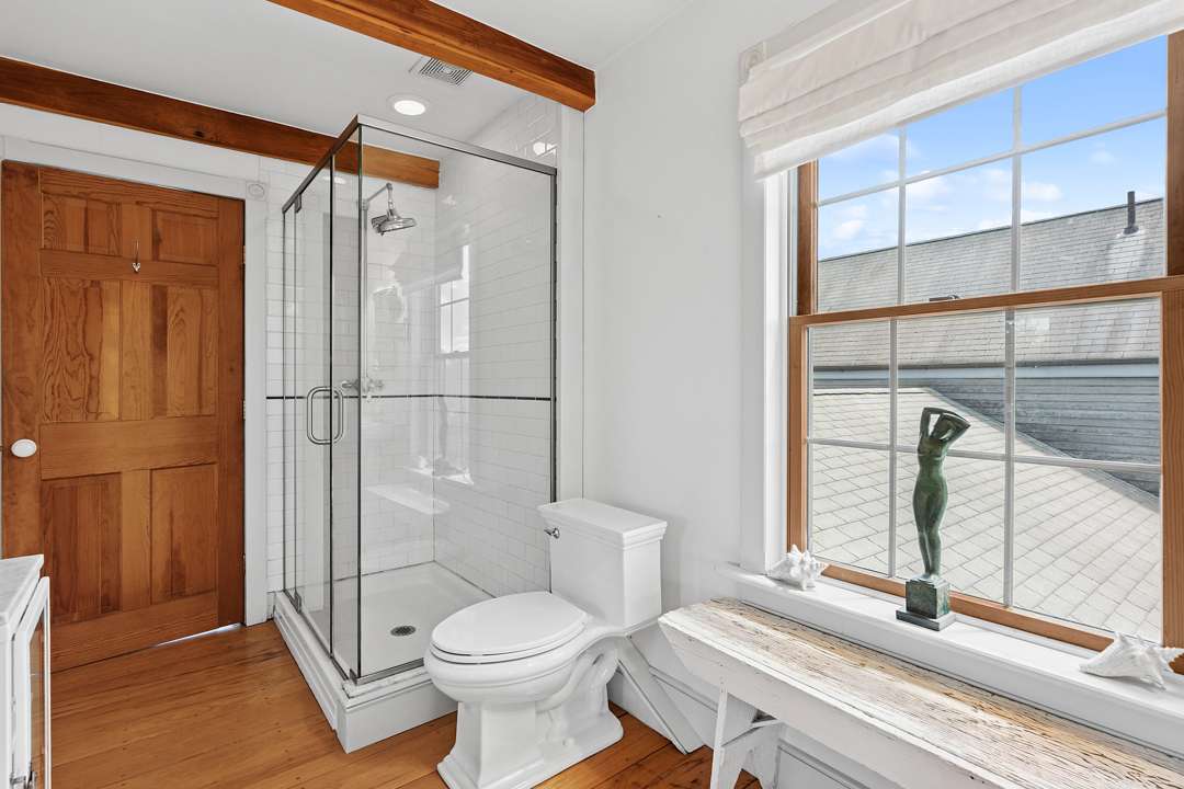 White bathroom with silver and wood accents