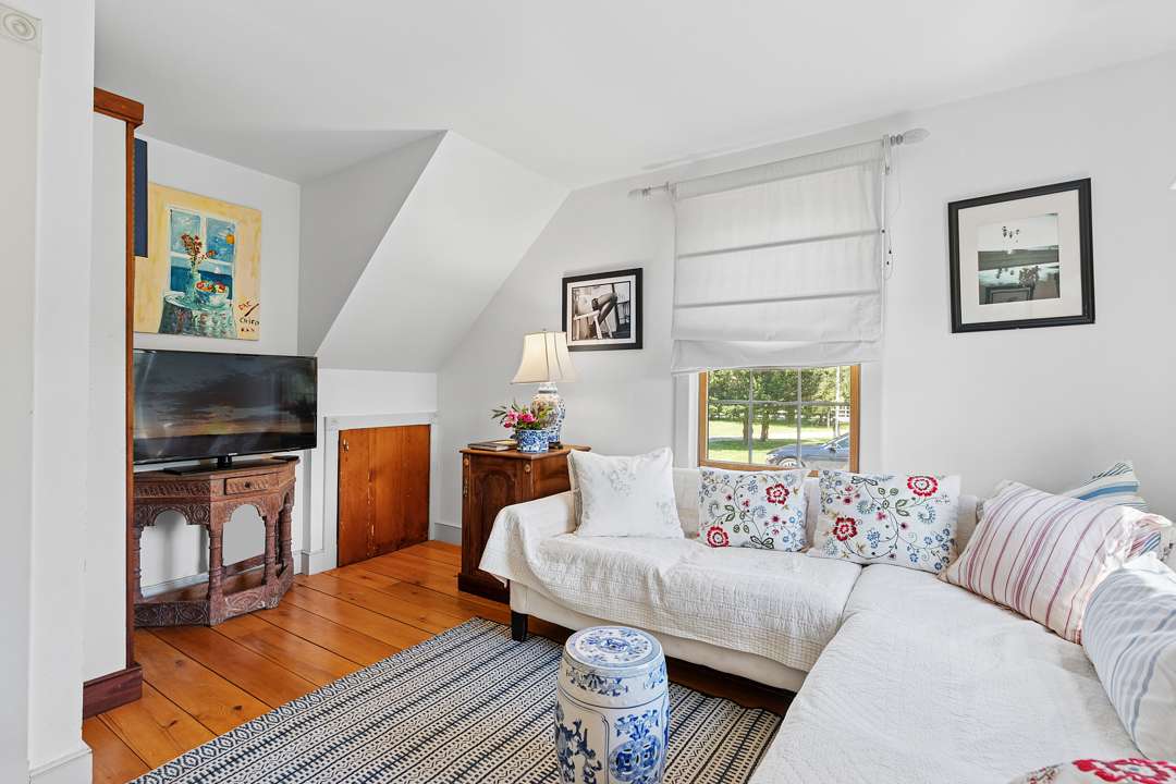 Living room with white couch and blue and pink accents