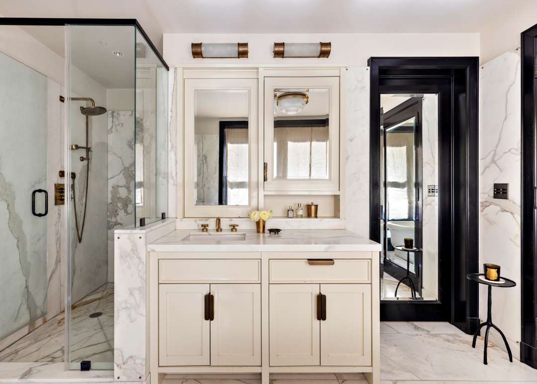 White marble bathroom with gold and black accents