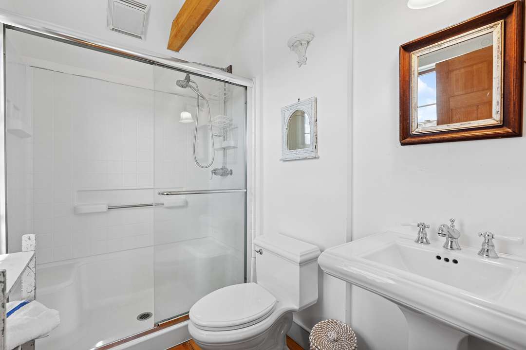 White bathroom with silver and wood accents