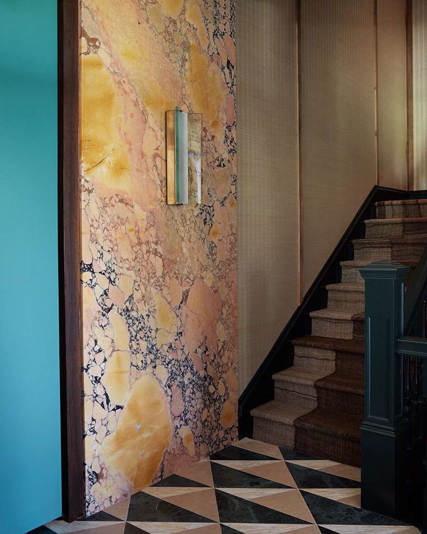 Pink and gold marble wall by stairs