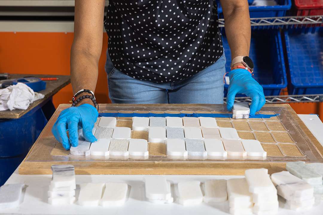 Hand laying a Custom Slide into a tray
