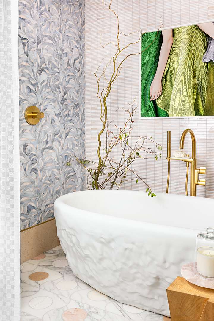 Bathroom with white marble tub and blue and white marble wall