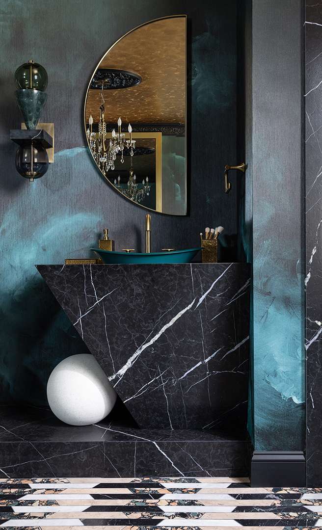 Black, emerald, and gold bathroom with marble sink counter