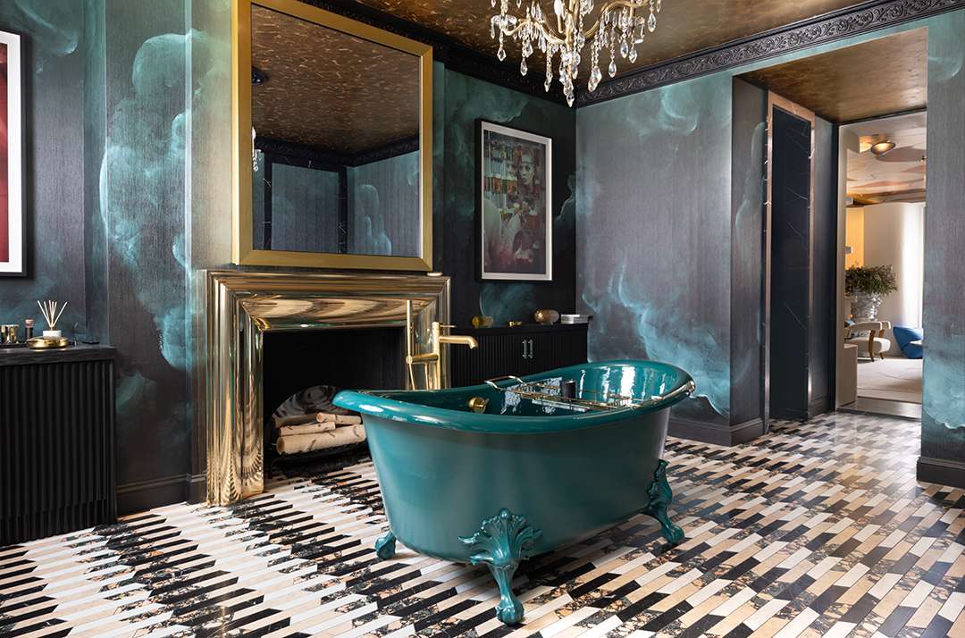 Black, gold, and emerald bathroom with fire place and emerald stand alone tub