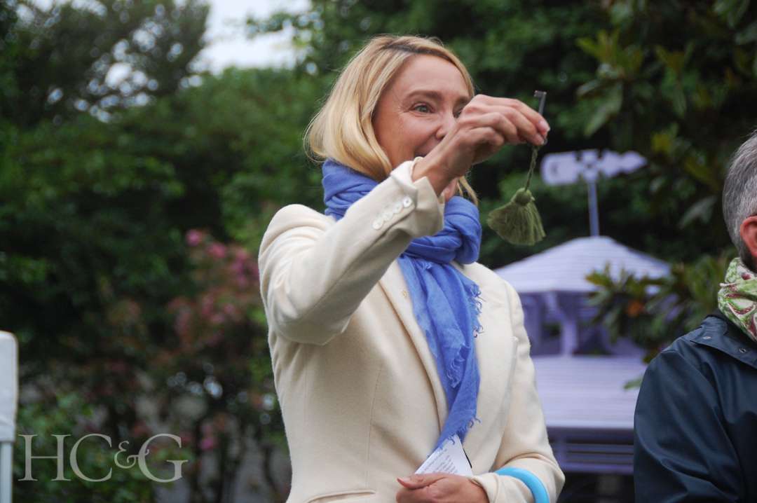 Meagan Ouderkirk holding a green fringed key at Much Ado About Madoo Cocktail Party 2025