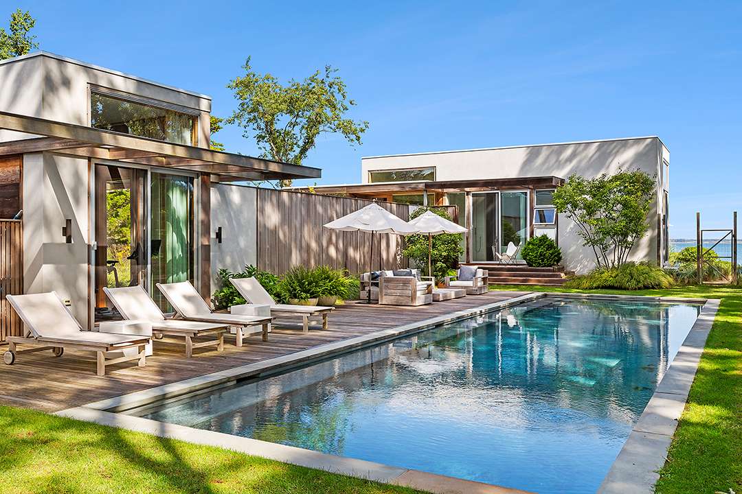 East Hampton pool with neutral chaise lounges
