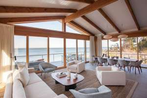 Grey and white living room and dining room overlooking the bay