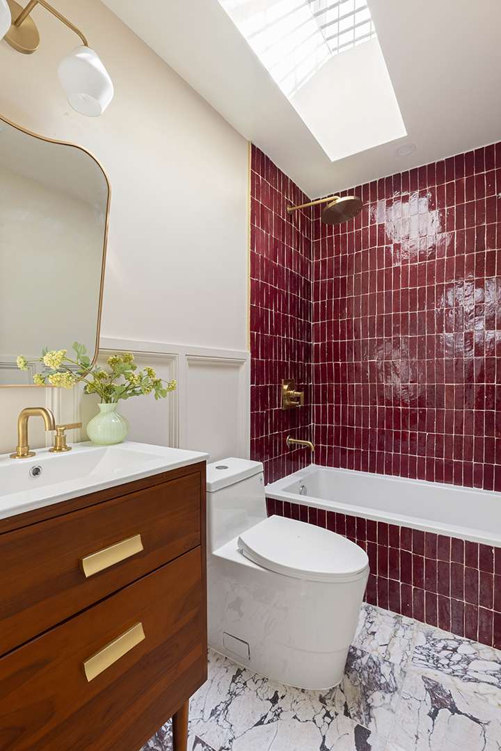 Bathroom with Marble Flooring and Red Bath and Shower Tiling