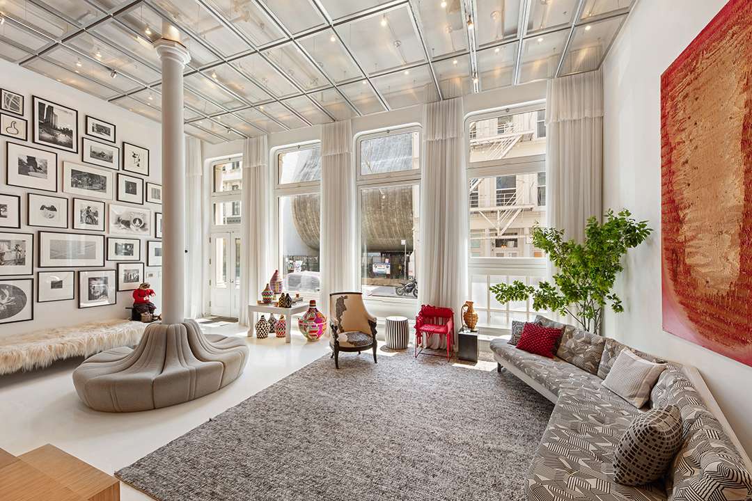 White and grey formal living room with round bench