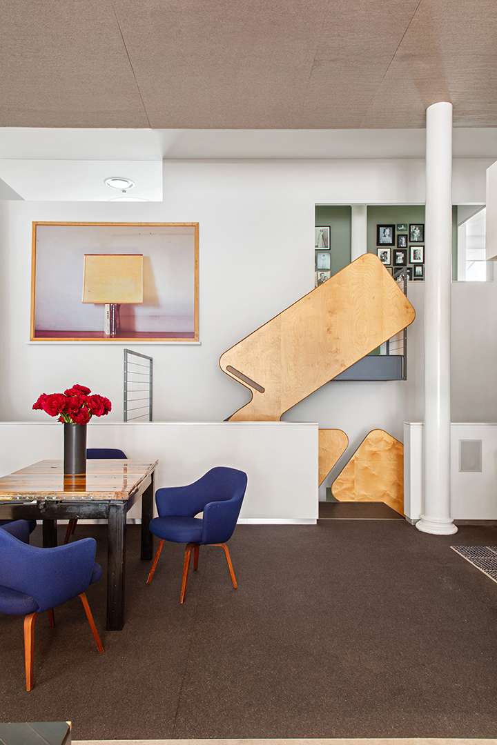 Abstract art in brown carpeted dining area