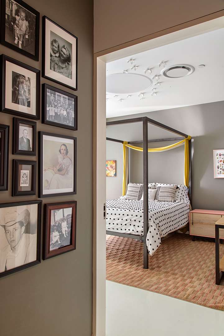 Bedroom with black and white polka dot bedding and white steel butterflies on the ceiling
