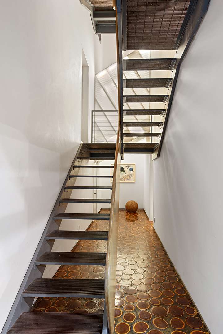 Wood staircase in Tribeca Triplex and brown spotted floor