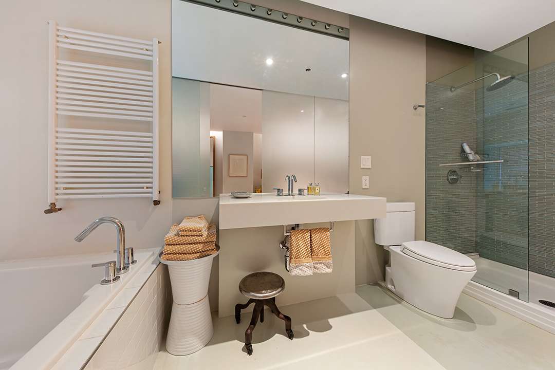 Neutral primary bathroom with grey shower tile