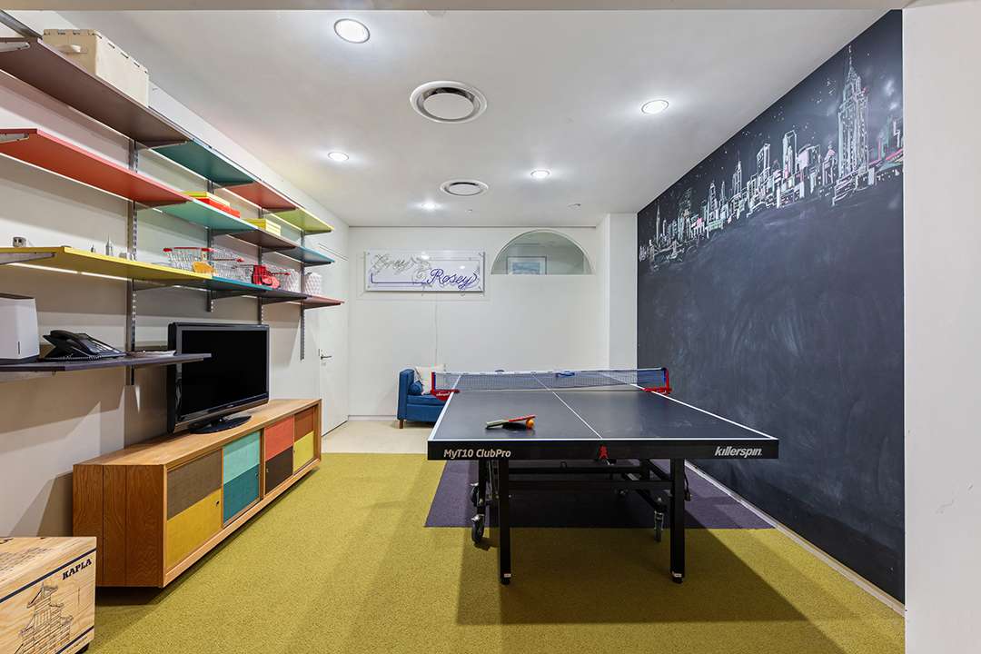 Game room with ping pong table and chalkboard wall