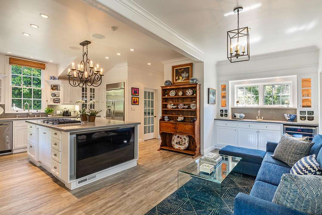 Kitchen and small living room with blue couch at Audrey Hepburn's former LA mansion