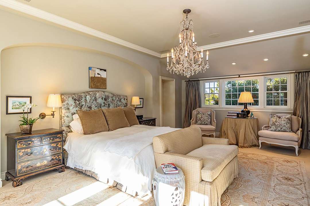Neutral bedroom with floral accents at Audrey Hepburn's former LA mansion