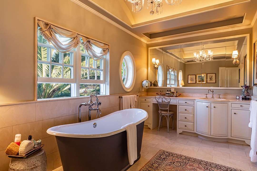 Bathroom with black tub and white storage at Audrey Hepburn's former LA mansion