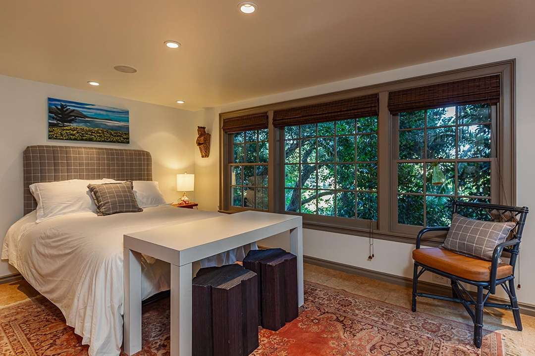 Neutral bedroom with Persian rug at Audrey Hepburn's former LA mansion