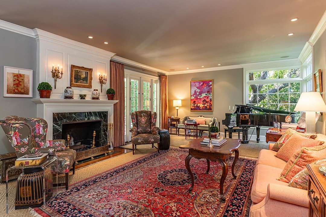 Living room with Persian rug and Asian armchairs at Audrey Hepburn's former LA mansion