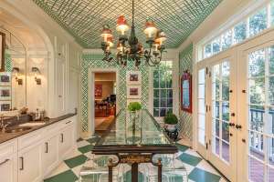 Green butler's pantry with glass seating area at Audrey Hepburn's former LA mansion