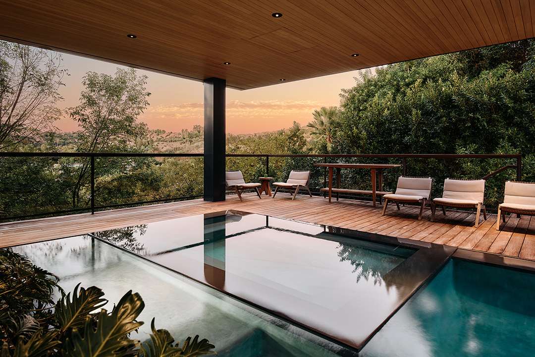 Lizzo's pool with wood deck and built-in hot tub