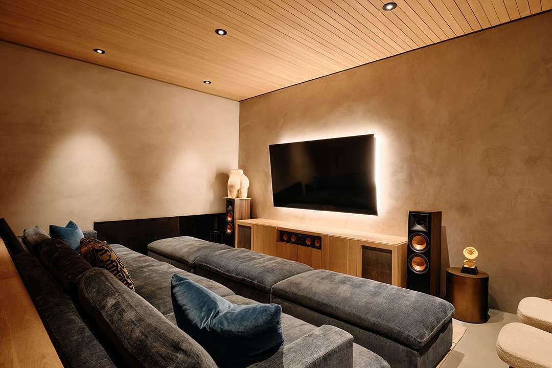 Lizzo's theater room with grey couches