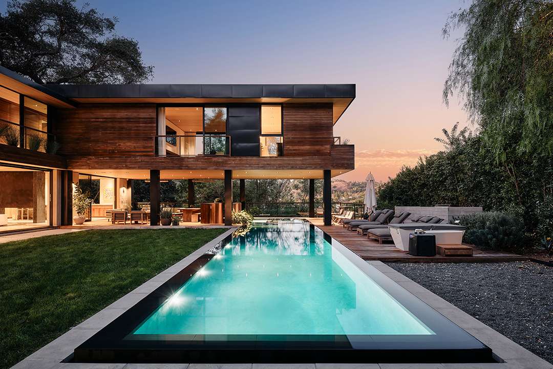 Lizzo's pool outside wood modern mansion in LA