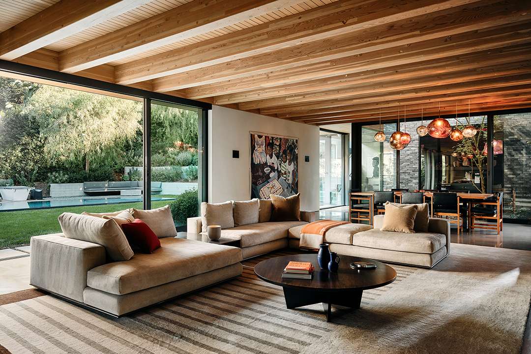 Lizzo's neutral living room with access to backyard