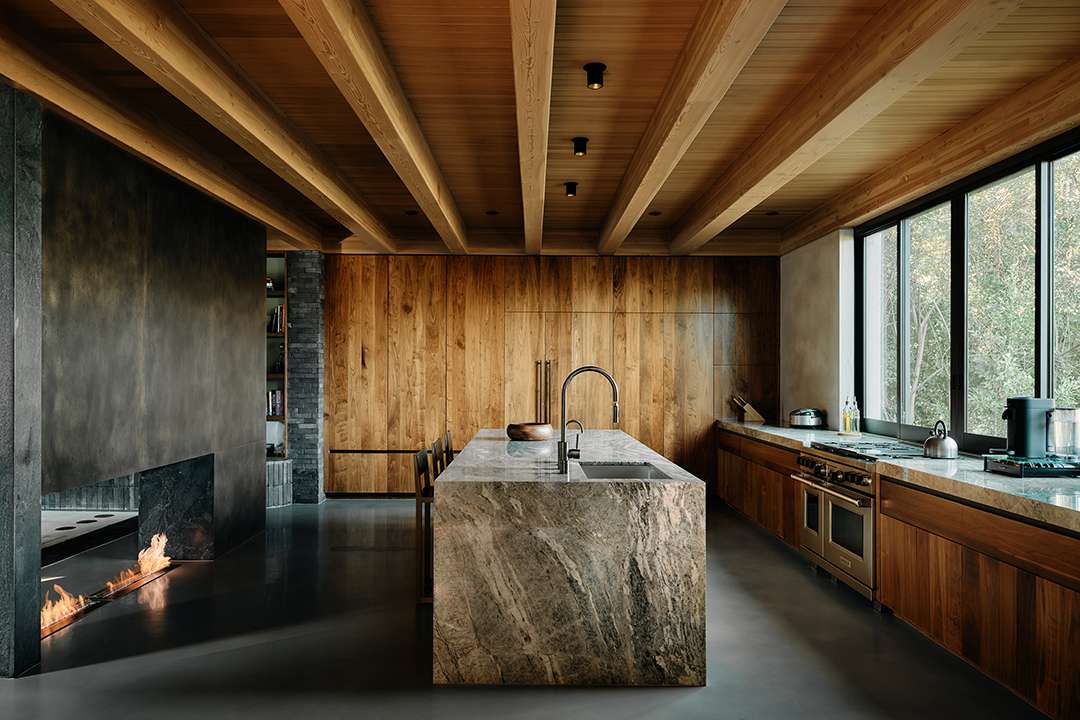 Lizzo's wood and marble outdoor kitchen with a fireplace