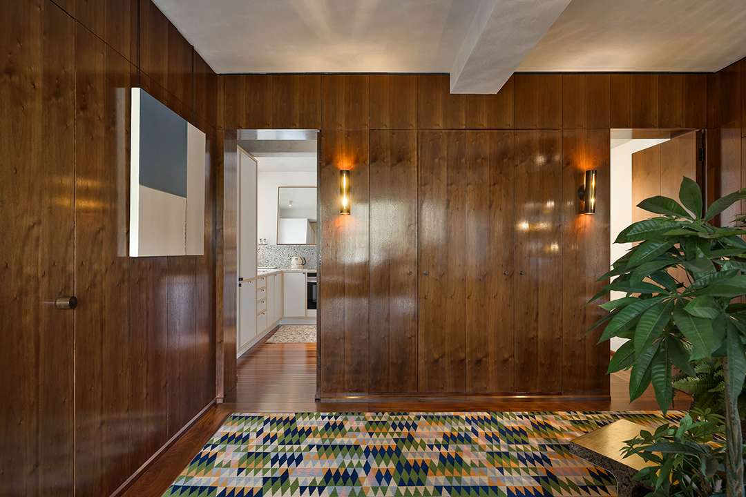 Wood walls and doors and colorful carpet