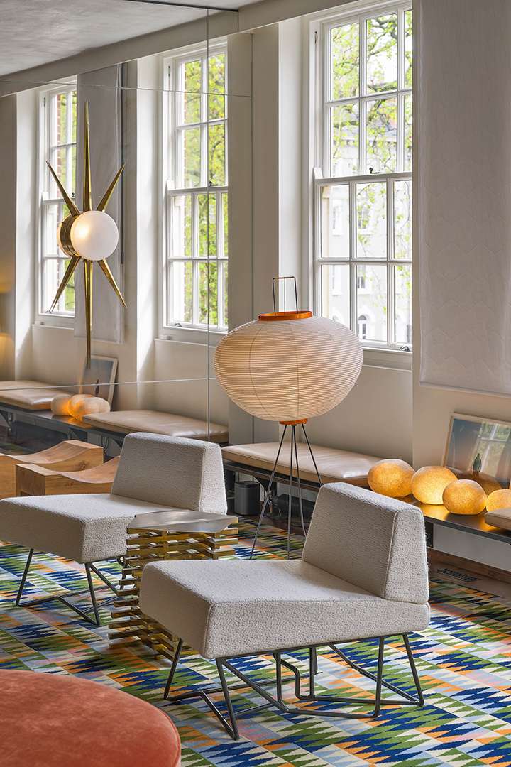 Living room with round lamp and colorful carpet
