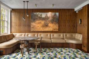 Beige lounge bench with wood walls