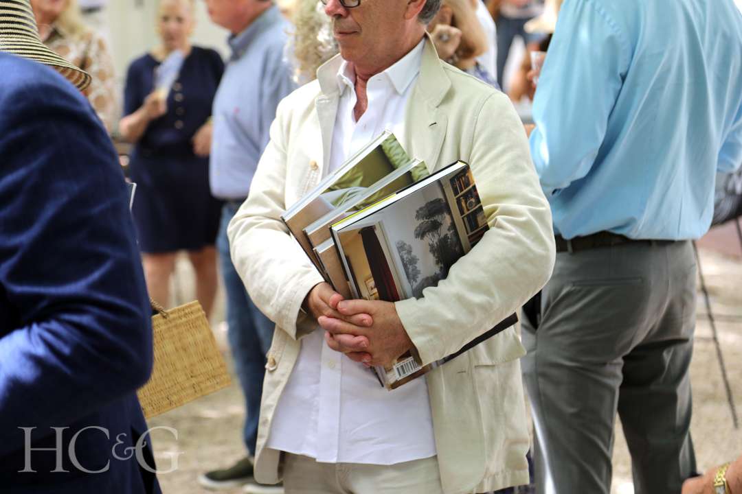 Guest holding books at East Hampton Art & Design Days