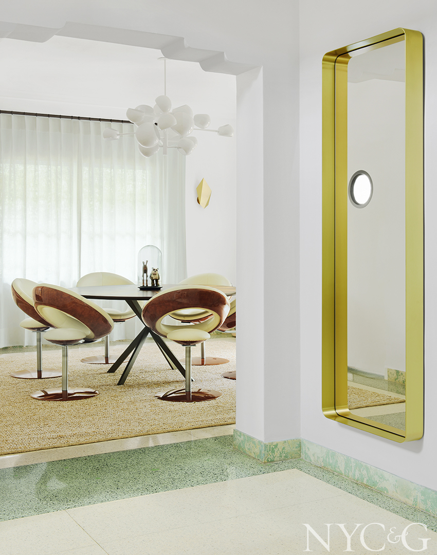 Bright entryway with a brass Cypris mirror