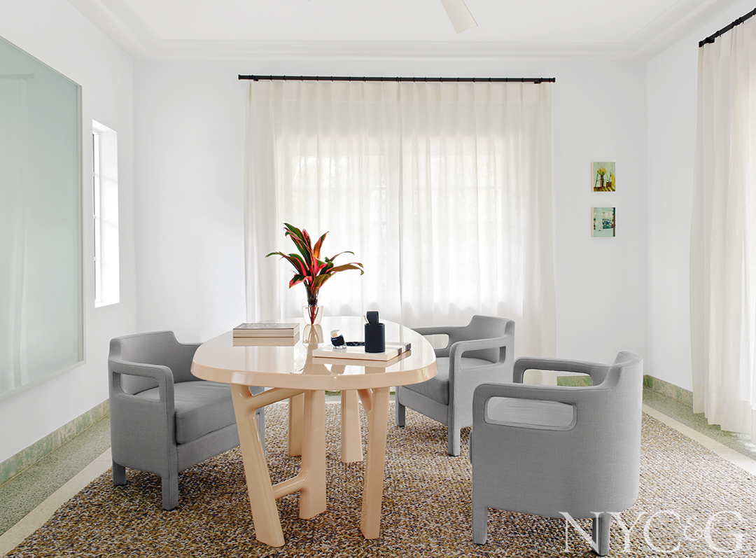 A French lacquered oak table centers this office space