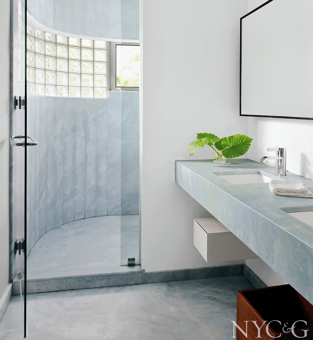 Welcoming bathroom with marble floor, vanity and shower