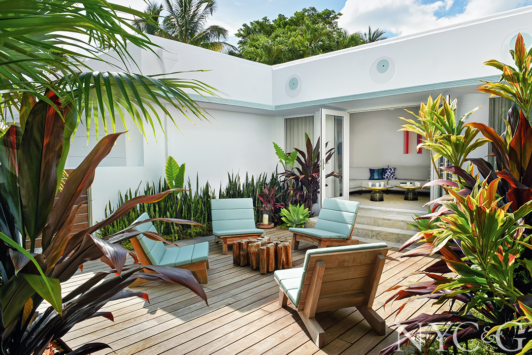 Modern chairs sit on the ipe terrace