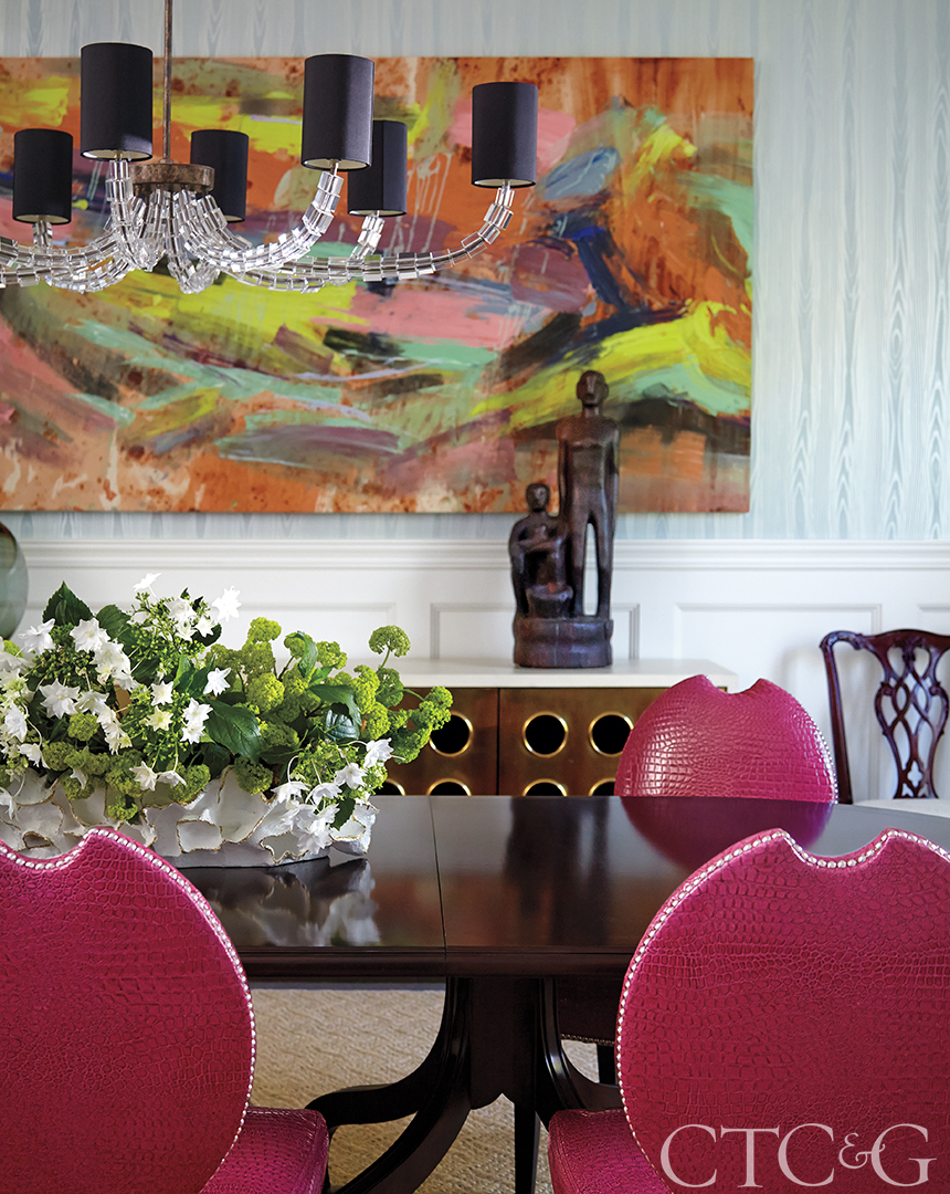 Dining room with pink leather chairs and colorful Amy Simon painting