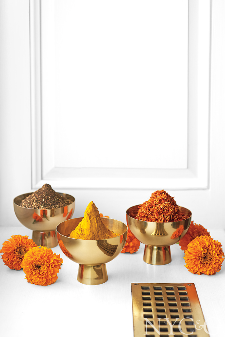 Gold bowls hold heaps of chai, turmeric, and safflower