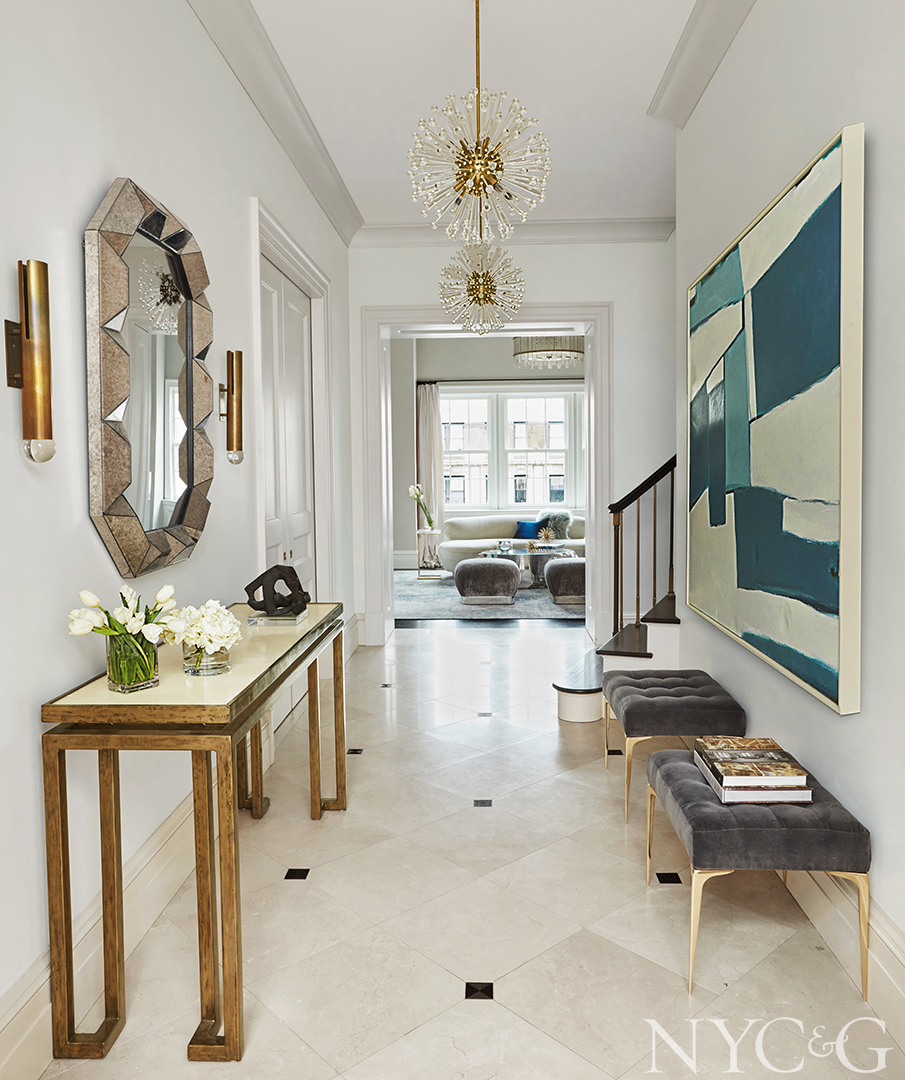 Velvet benches and glass chandeliers decorate entry hallway